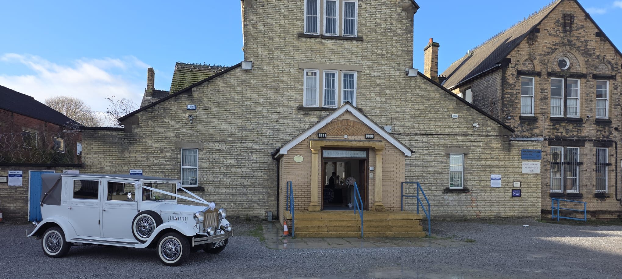 Wedding celebration outside Beverley Road Masonic Hall in Hull, showing guests gathered in front of the historic building.
